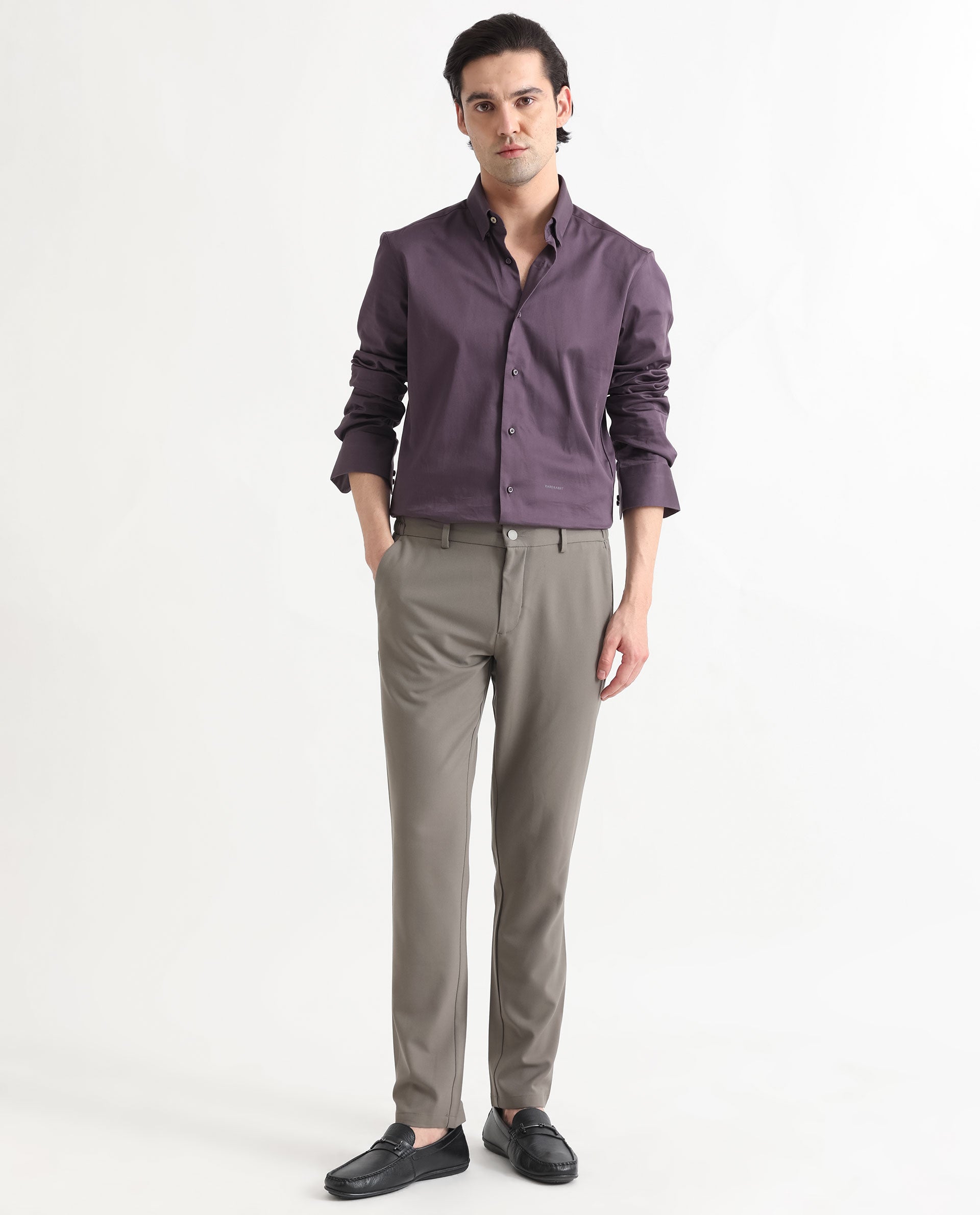 Gray-haired blue-eyed man with a short beard fascinator with short hair,  human, natural skin color in purple shirt to the elbows gold strings and  black pants and boots. stands in full growth